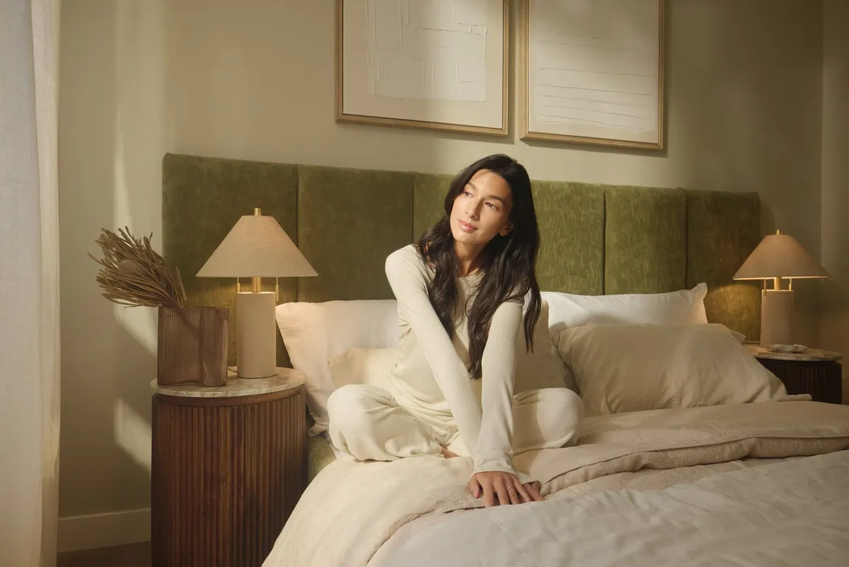 Lifestyle video shoot — woman in cozy bedroom interior